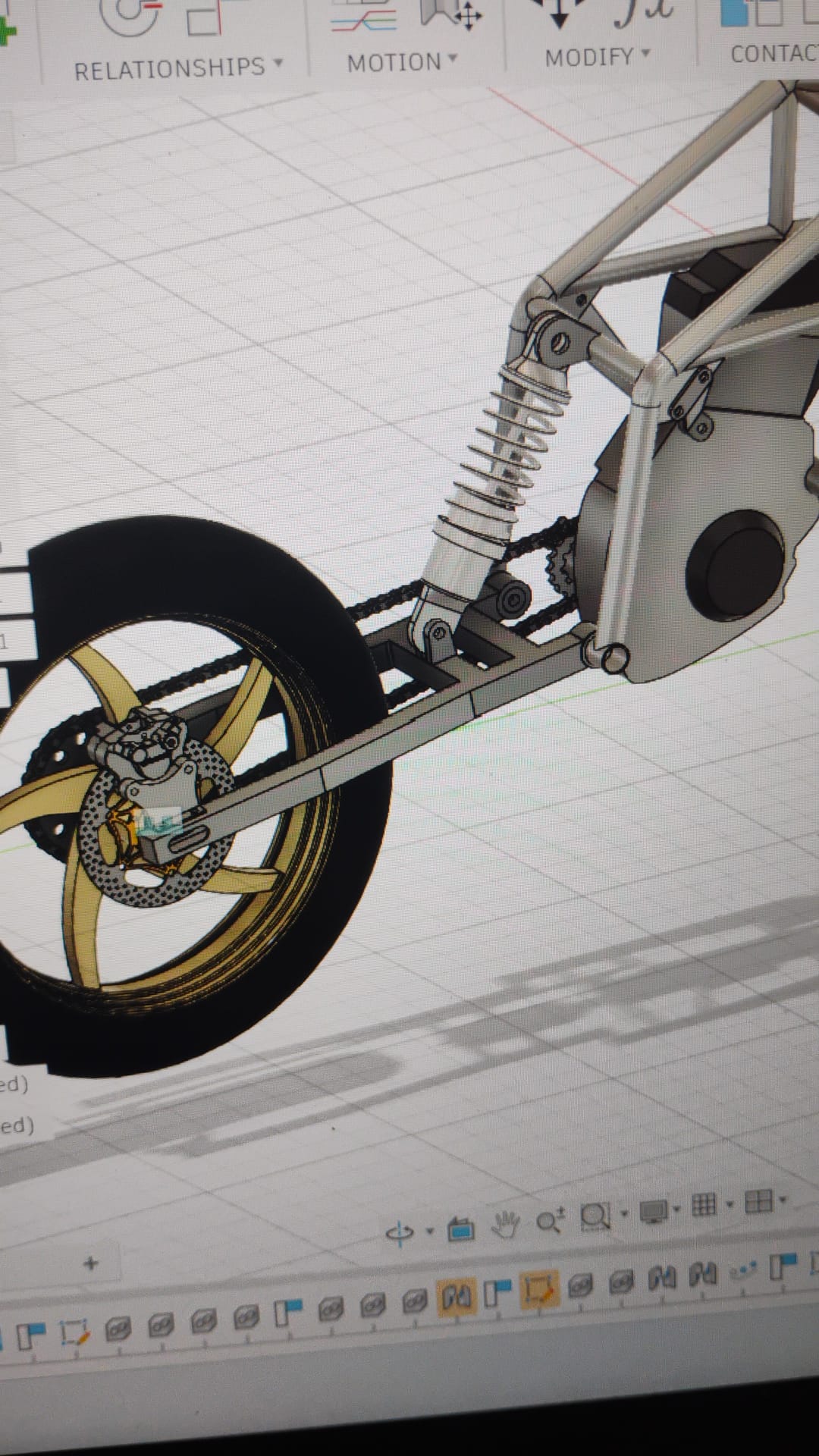 Close-up CAD of the rear wheel and swingarm assembly